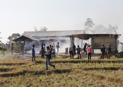 Tribal plantation workers burn houses belonging to indigenous Bodo tribesmen after ethnic clashes in Balijuri village, in Sonitpur district in the northeastern Indian state of Assam, December 24, 2014. PHOTO BY REUTERS/Stringer