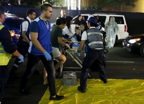 Medics evacuate a wounded person outside the Address Downtown Dubai hotel and residential block after a fire engulfed the skyscraper in downtown Dubai in the United Arab Emirates, December 31, 2015. PHOTO BY REUTERS/Ahmed Jadallah