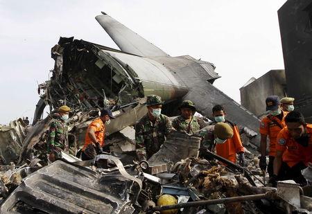 Indonesian soldiers and search and rescue teams remove debris from the crash site of a military C-130 transport plane which went down yesterday in a residential area of Medan, North Sumatra, Indonesia, July 1, 2015. PHOTO BY REUTERS/Roni Bintang
