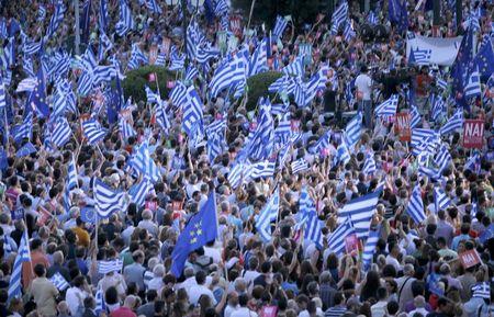 'Yes' supporters wave Greek flags during a pro-Euro rally next to the Panathenean stadium in Athens, Greece, July 3, 2015. PHOTO BY REUTERS/Marko Djurica