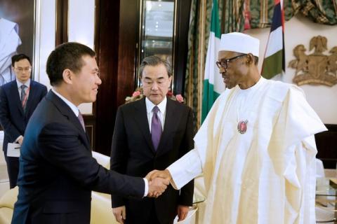 Nigeria's President Muhammadu Buhari greets China's Foreign Minister Wang Yi (C) and Chinese Ambassador to Nigeria Zhou Pingjian during their visit to the Presidential Villa in Abuja, Nigeria, January 11, 2017. PHOTO BY REUTERS/Stringer