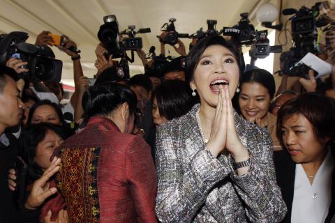 Ousted former Prime Minister Yingluck Shinawatra greets in a traditional way as she leaves Parliament after delivering a statement during the National Legislative Assembly meeting in Bangkok, Thailand, January 22, 2015. PHOTO BY REUTERS/Chaiwat Subprasom