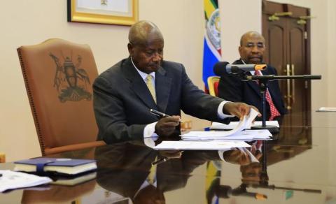 Uganda's President Yoweri Museveni signs an anti-homosexual bill into law at the state house in Entebbe, 36 km (22 miles) southwest of the capital Kampala