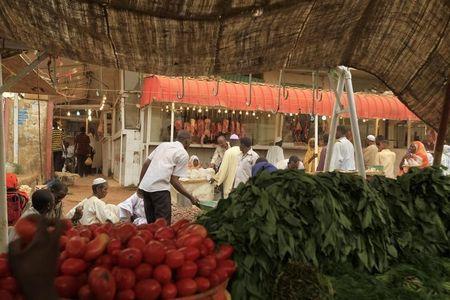 Men wait to buy food for Ramadan at Khartoum's central food market July 18, 2012. REUTERS/ Mohamed Nureldin Abdallah