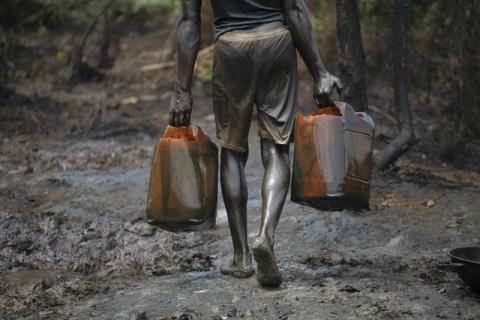 A man works at an illegal oil refinery site near river Nun in Nigeria's oil state of Bayelsa. PHOTO BY REUTERS/Akintunde Akinleye