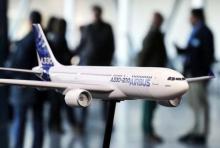 People speak together near a scale model of an Airbus A330-200 during the Airbus annual news conference in Colomiers, near Toulouse, January 13, 2015. PHOTO BY REUTERS/Regis Duvignau