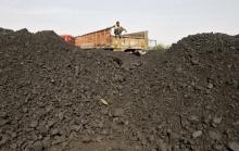 A worker sits on a truck as he waits for the loading of coal at a railway coal yard on the outskirts of the western Indian city of Ahmedabad, November 25, 2013. PHOTO BY REUTERS/Amit Dave