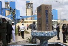 Security officials wait outside a building after Nigeria's Ex-President Goodluck Jonathan unveiled a plaque during a commissioning ceremony at Dangote cement factory in Obajana in Nigeria's central state of Kogi June 11, 2012. REUTERS/Akintunde Akinleye