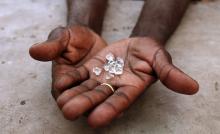 A diamond dealer from Zimbabwe displays diamonds for sale in Manica, near the border with Zimbabwe. PHOTO BY REUTERS/Goran Tomasevic