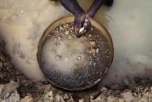 An artisanal miner pans for diamonds in the town of Koidu, in eastern Sierra Leone. PHOTO BY REUTERS/Finbarr O'Reilly