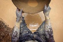 Artisanal gold miner Mamadou Diarra pans for gold at a small scale mine in Kalana, August 26, 2012. PHOTO BY REUTERS/Joe Penney