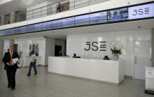 People walk near the reception at the Johannesburg Stock Exchange (JSE) in Sandton, Johannesburg, South Africa, December 10, 2015. PHOTO BY REUTERS/Siphiwe Sibeko