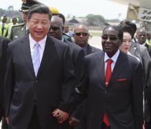 Chinese President Xi Jinping walks with Zimbabwean President Robert Mugabe on arrival for a state visit in Harare, Zimbabwe, December 1, 2015. PHOTO BY REUTERS/Philimon Bulawayo