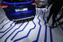 Visitors walk along a Ford Kuga car during the media day at the Frankfurt Motor Show (IAA) in Frankfurt, Germany, September 16, 2015. PHOTO BY REUTERS/Ralph Orlowski