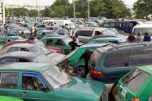 A man works on the engine of his car, as motorists gather at a petrol station of state-owned energy company Nigerian National Petroleum Corporation (NNPC) in Abuja, Nigeria, May 25, 2015. PHOTO BY REUTERS/Afolabi Sotunde
