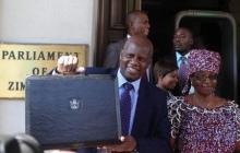 Zimbabwe's Finance Minister Patrick Chinamasa (L) arrives with his wife Monica to deliver the 2015 national budget to the parliament in Harare, November 27, 2014. PHOTO BY REUTERS/Philimon Bulawayo