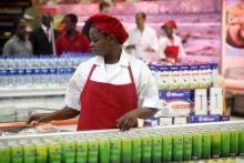 A shop assistant arranges products at the South African firm Shoprite's main store in Nigeria's commercial capital Lagos, file. PHOTO BY REUTERS/Akintunde Akinleye