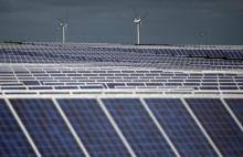 A solar power plant is seen past wind turbines in Canino, central Italy, April 27, 2016. PHOTO BY REUTERS/Max Rossi