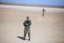 Soldiers stand guard at a Krechba gas treatment plant, south of Algiers, in this December 14, 2008 file photo. PHOTO BY REUTERS/Zohra Bensemra