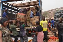 Workers unload tomatoes from a pick-up truck at a market in Enugu, Nigeria, February 24, 2016. PHOTO BY REUTERS/Stringer