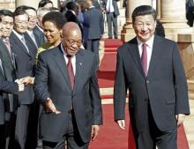 Chinese President Xi Jinping walks with South African President Jacob Zuma upon his arrival at the Union Buildings in Pretoria , December 2, 2015. PHOTO BY REUTERS/Sydney Seshibedi