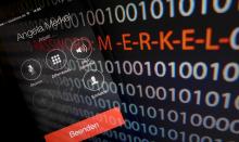 A mobile phone simulating a call to German Chancellor Angela Merkel and computer with a series of numbers