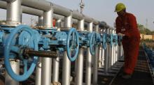A technician opens a pressure gas valve inside the Oil and Natural Gas Corp