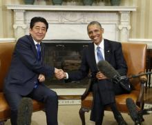 U.S. President Barack Obama (R) greets Japanese Prime Minister Shinzo Abe during a White House Oval Office meeting in Washington, April 28, 2015. PHOTO BY REUTERS/Kevin Lamarque