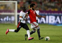 Uganda’s Godfrey Walusimbi in action with Egypt’s Mohamed Salah. PHOTO BY REUTERS/Amr Abdallah Dalsh