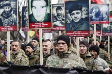 Activists of the Right Sector political party carry portraits of their comrades killed in fighting with pro-Russian separatists during an anti-government march in Kiev, February 25, 2015. PHOTO BY REUTERS/Valentyn Ogirenko