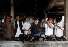 Afghans inspect copies of the Koran burnt inside a Shi'ite Muslim mosque after yesterday's attack in Kabul, Afghanistan, August 26, 2017. PHOTO BY REUTERS/Mohammad Ismail