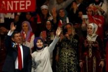 Turkish Prime Minister Ahmet Davutoglu and his wife Sare greet their supporters as they arrive to the 5th AK Party (AKP) Congress in Ankara, Turkey, September 12, 2015. PHOTO BY REUTERS/Umit Bektas