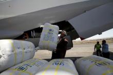 Aid packages from relief agencies are unloaded at Sanaa International Airport, May 16, 2015. PHOTO BY REUTERS/Mohamed al-Sayaghi