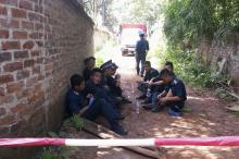 Airforce personnel guard the area outside the site of a military helicopter crash, outside Hanoi