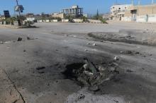 A crater is seen at the site of an airstrike, after what rescue workers described as a suspected gas attack in the town of Khan Sheikhoun in rebel-held Idlib, Syria, April 4, 2017. PHOTO BY REUTERS/Ammar Abdullah