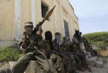 Al Shabaab soldiers sit outside a building during patrol along the streets of Dayniile district in Southern Mogadishu, March 5, 2012. PHOTO BY REUTERS/Feisal Omar