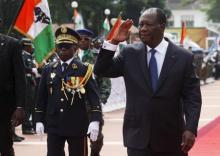 Ivory Coast's President Alassane Ouattara (R) salutes while walking next to Chief of Staff, General Soumaila Bakayoko (L) during a parade to commemorate the country's 55th Independence Day, outside the presidential palace in Abidjan, August 7, 2015. PHOTO BY REUTERS/Luc Gnago
