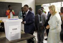 Ivory Coast's President Alassane Ouattara of the Rally of the Houphouetists for Democracy and Peace (RHDP) party and his wife Dominique prepare to cast their votes at a polling station during a presidential election in Abidjan, Ivory Coast, October 25, 2015. PHOTO BY REUTERS/Luc Gnago