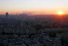 The sun rises while smoke is pictured near Aleppo's historic citadel, as seen from a government-controlled area of Aleppo, Syria, December 6, 2016. PHOTO BY REUTERS/Omar Sanadiki