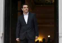 Greek Prime Minister Alexis Tsipras waits for European Parliament President Martin Schulz outside the Greek Premier's office in Athens, January 29, 2015. PHOTO BY REUTERS/Marko Djurica