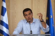 Greek Prime Minister Alexis Tsipras delivers his speech as he attends a news conference after a meeting at the Greek Ministry of Infrastructure, Transport and Networks in Athens, Greece, August 12, 2015. PHOTO BY REUTERS/Christian Hartmann
