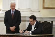 Leftist Syriza leader and winner of Greek general election Alexis Tsipras signs documents as he is sworn in as prime minister during a ceremony at the presidential palace in Athens, September 21, 2015. PHOTO BY REUTERS/Alkis Konstantinidis