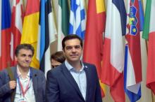 Greece's Prime Minister Alexis Tsipras (C) and Greek Finance Minister Euclid Tsakalotos (L) leave a euro zone leaders summit in Brussels, Belgium, July 13, 2015. PHOTO BY REUTERS/Eric Vidal