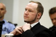Norwegian mass killer Anders Behring Breivik adjusts his tie as the Oslo Court delivered the verdict of his trial in Oslo Courthouse, Norway, in this August 24, 2012 file photo. PHOTO BY REUTERS/Heiko Junge