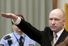 Mass killer Anders Behring Breivik raises his arm in a Nazi salute as he enters the court room in Skien prison, Norway, March 15, 2016. PHOTO BY REUTERS/Lise Aserud