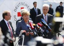 Heidenau major Juergen Opitz, German Chancellor Angela Merkel and Saxony State Prime Minister Stanislaw Tillich (L to R) arrive for statements after their visit to an asylum seekers accomodation facility in the eastern German town of Heidenau near Dresden, August 26, 2015. PHOTO BY REUTERS/Axel Schmidt