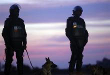 Angolan police officers stand guard outside Ombaka Stadium before an African Nations Cup semi-final soccer match between Egypt and Algeria