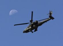 A U.S. Army Apache flies past the moon in the Zharay district of Kandahar province, southern Afghanistan, June 11, 2012. PHOTO BY REUTERS/Shamil Zhumatov