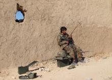 An Afghan National Army (ANA) soldier speaks on a radio at an outpost in Helmand province, December 20, 2015. PHOTO BY REUTERS/Abdul Malik