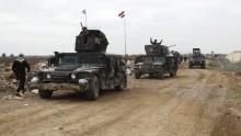 Iraqi security forces ride on military vehicles as they advance towards the center of Ramadi city, Iraq, December 24, 2015. PHOTO BY REUTERS/Stringer